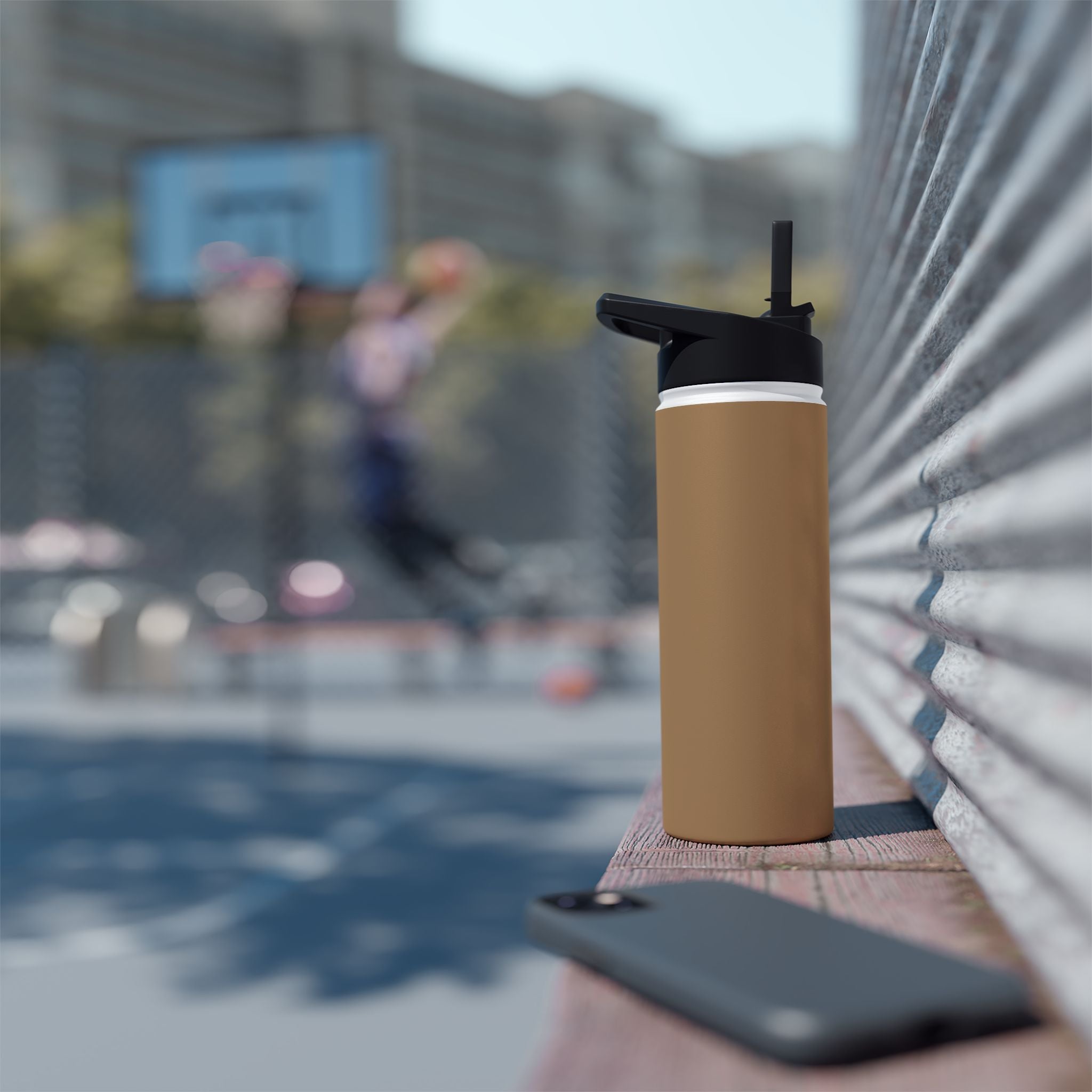 Sandstone insulated stainless steel water bottle with black sports lid on mat