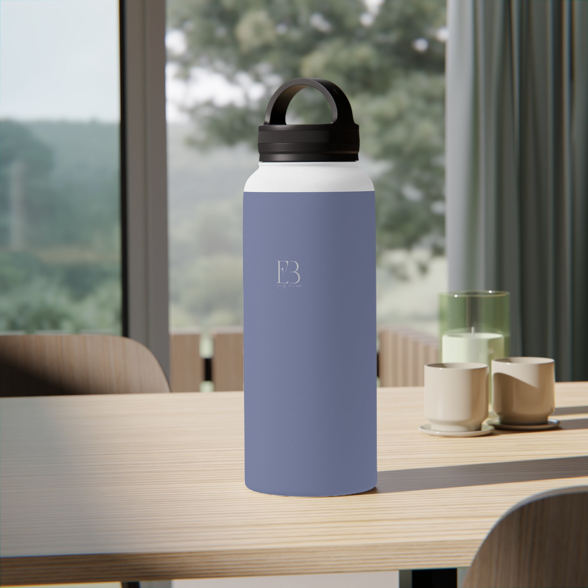 Pale iris insulated water bottle with black carry handle lid on table