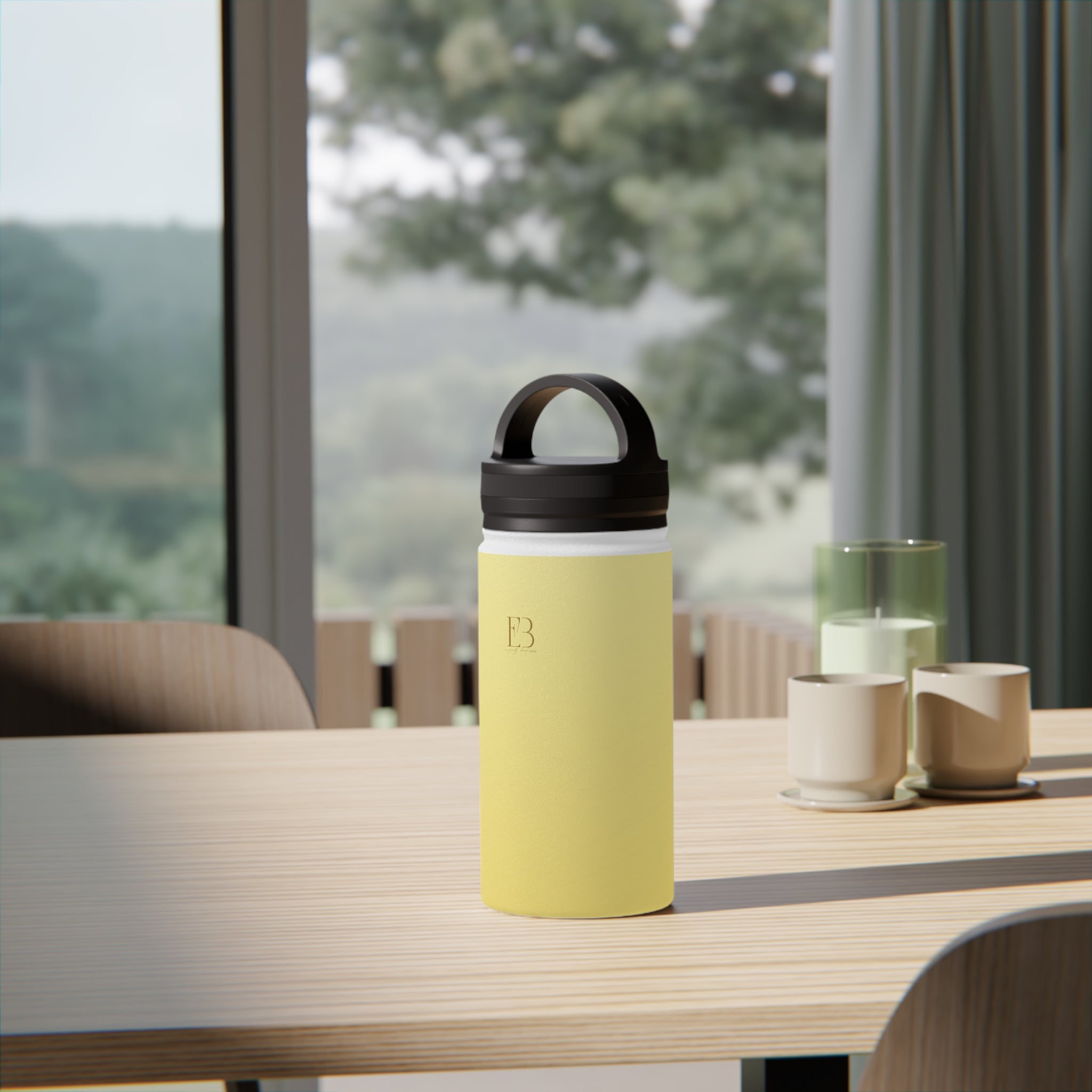 Insulated lemon yellow water bottle on a table with black lid and handle