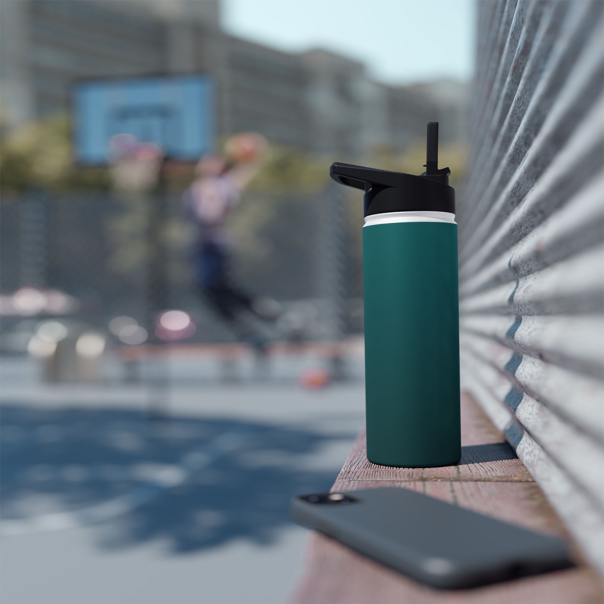 Deep teal insulated water bottle with sports lid on yoga mat