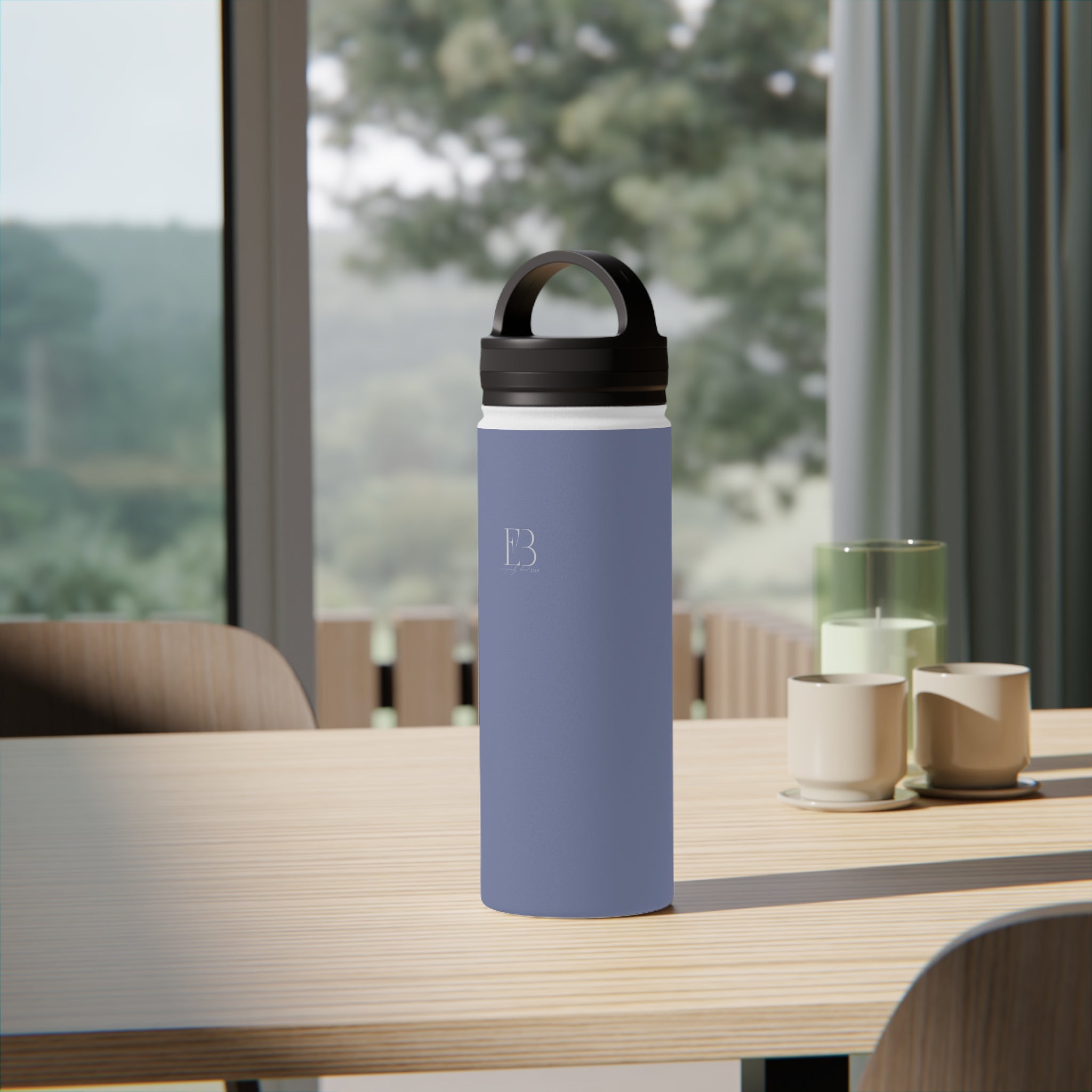 Pale iris insulated water bottle with black carry handle lid on table