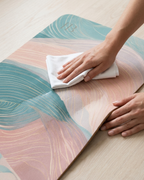 Close-up of pastel yoga mat top with pink and teal wave print and wipeable texture.