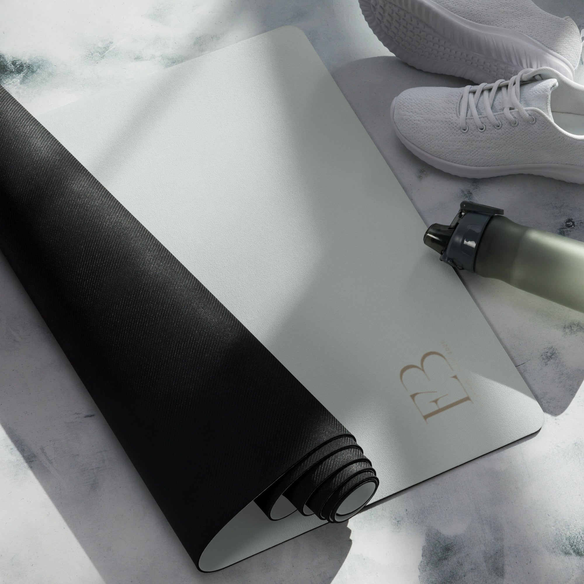 Misty sage yoga mat with black underside rolled edge, textured grip visible