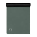 Rolled cypress green yoga mat with a dark cap at one end and logo mark.