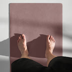 Mauve yoga mat showing textured grip surface with centered logo.