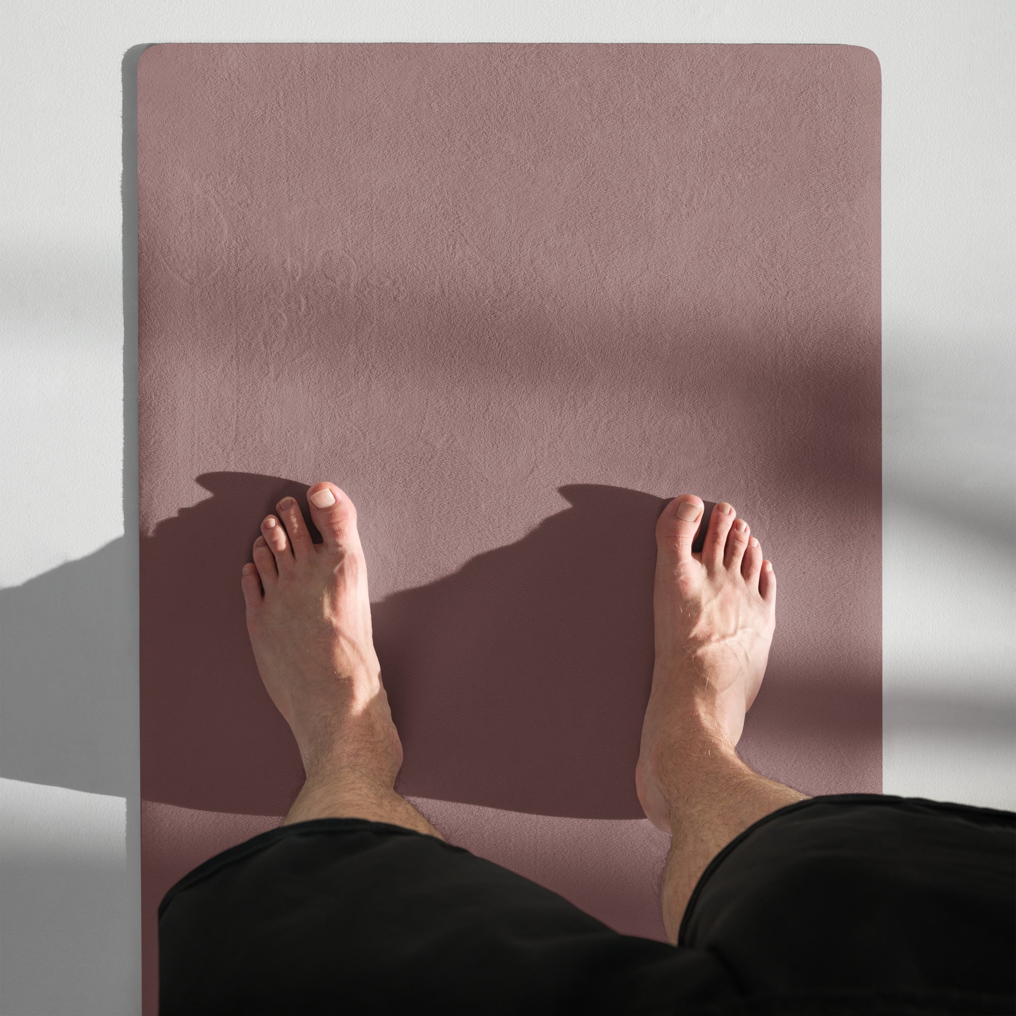 Mauve yoga mat showing textured grip surface with centered logo.