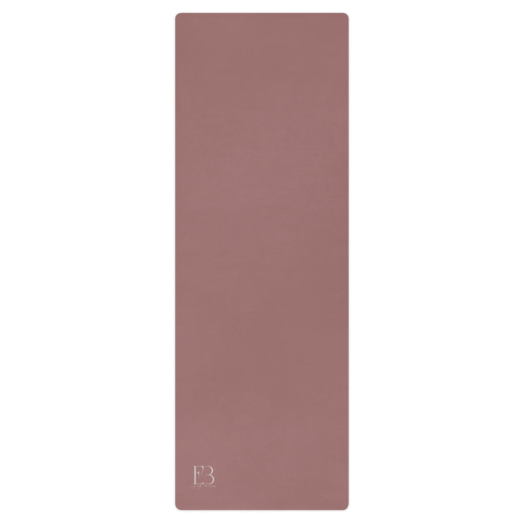 Clay mauve yoga mat with textured surface and logo mark at bottom.