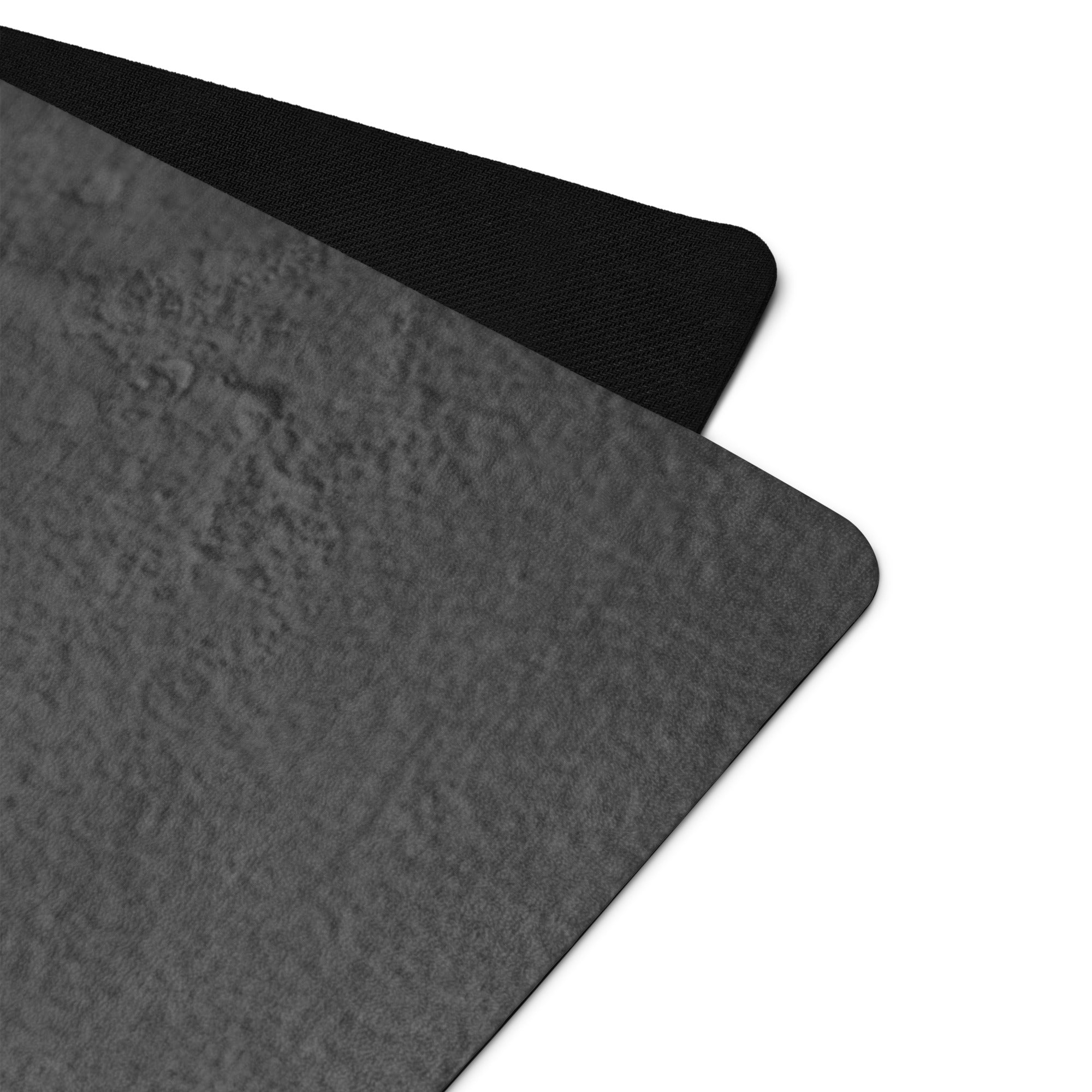 Dark gray yoga mat corner with raised surface detail. Eco Black Dark gray natural rubber yoga mat with Suede top 
