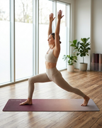 Dusty pink yoga mat in use for a lunge pose with textured grip surface