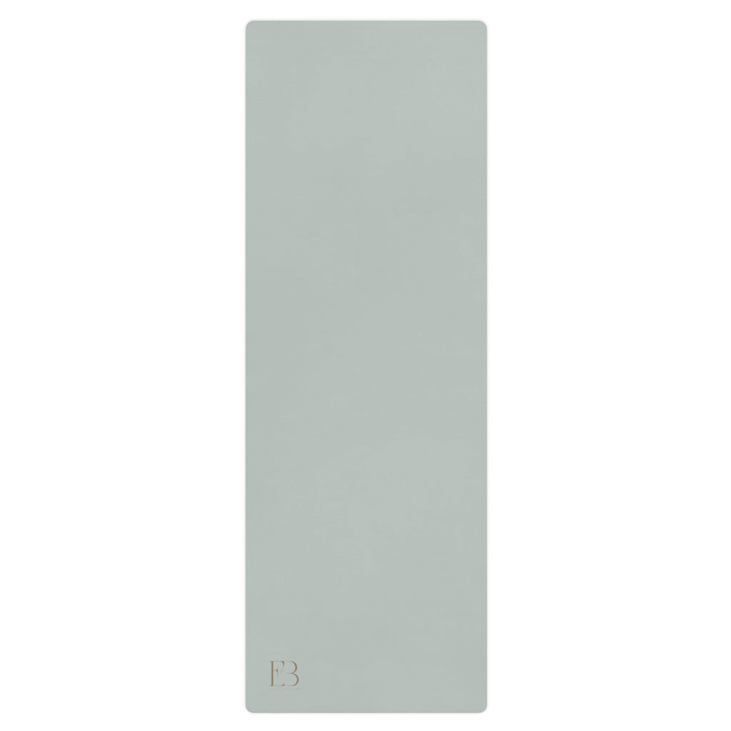 Misty sage natural rubber yoga mat, smooth surface with subtle logo at bottom