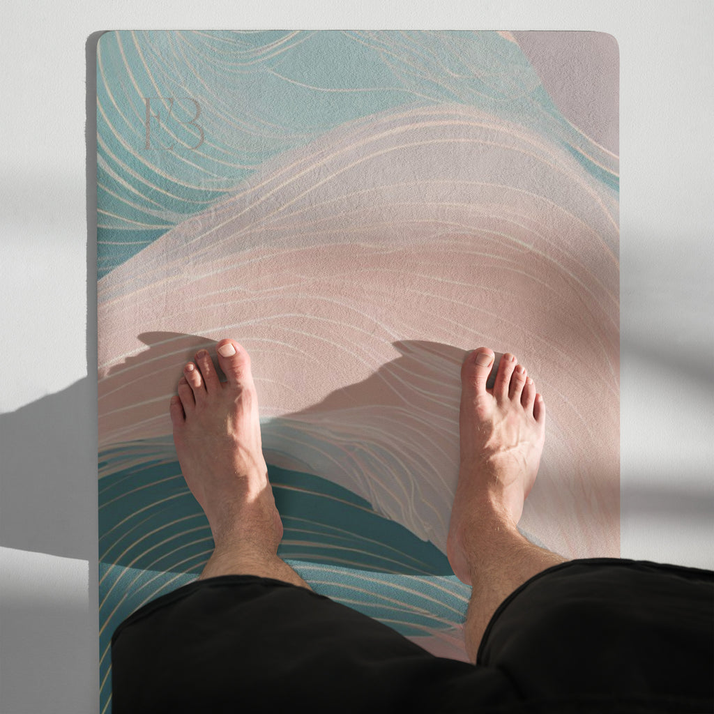 Natural rubber yoga mat in use with teal and pink swirl design