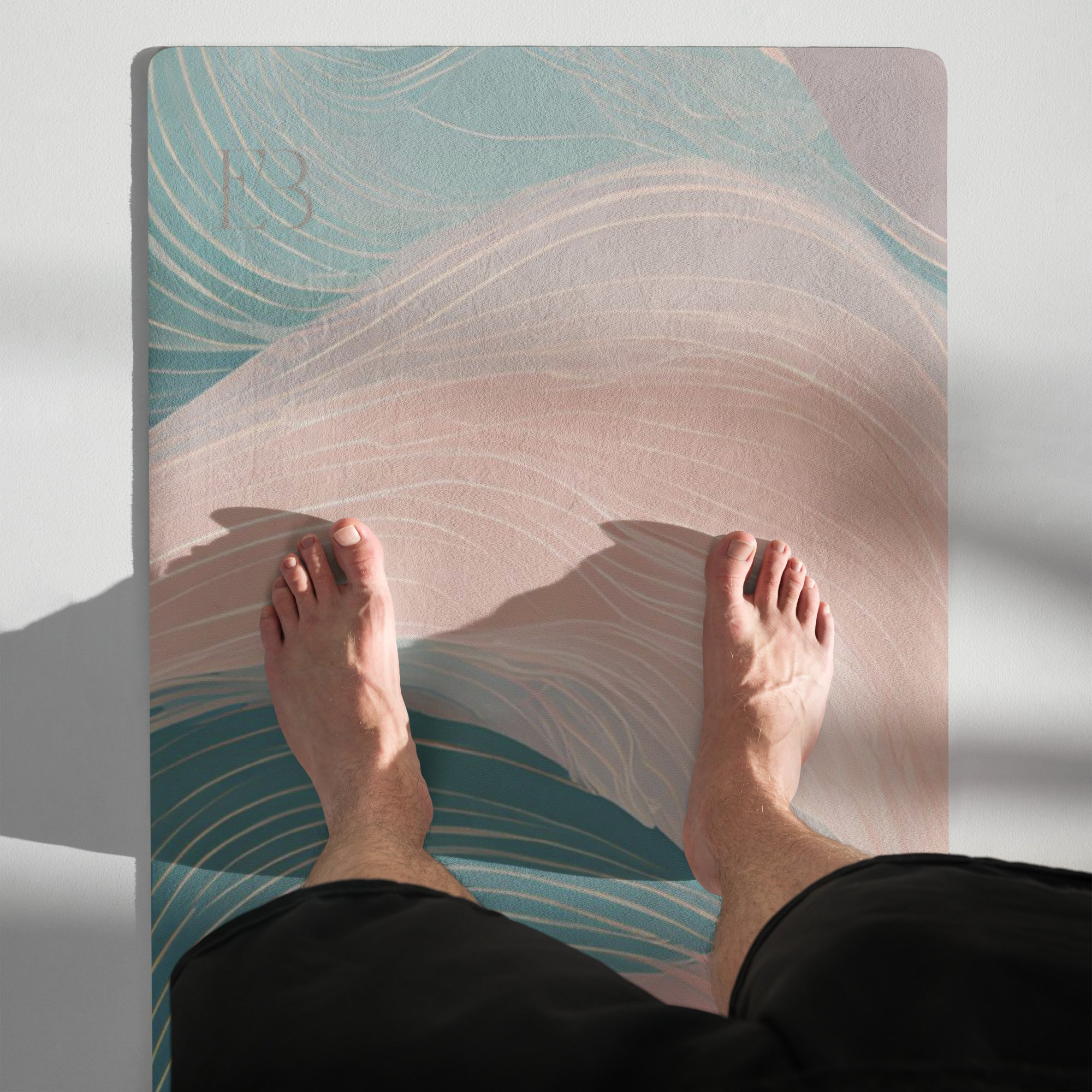Natural rubber yoga mat in use with teal and pink swirl design