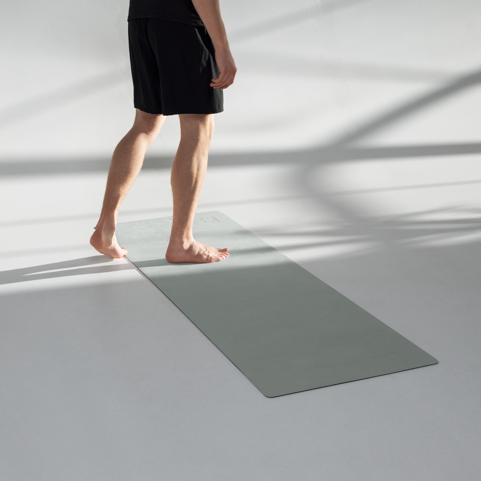 Refined performance yoga mat in sage green used during studio practice
