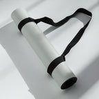 Light sage yoga mat rolled with black carrying strap loops