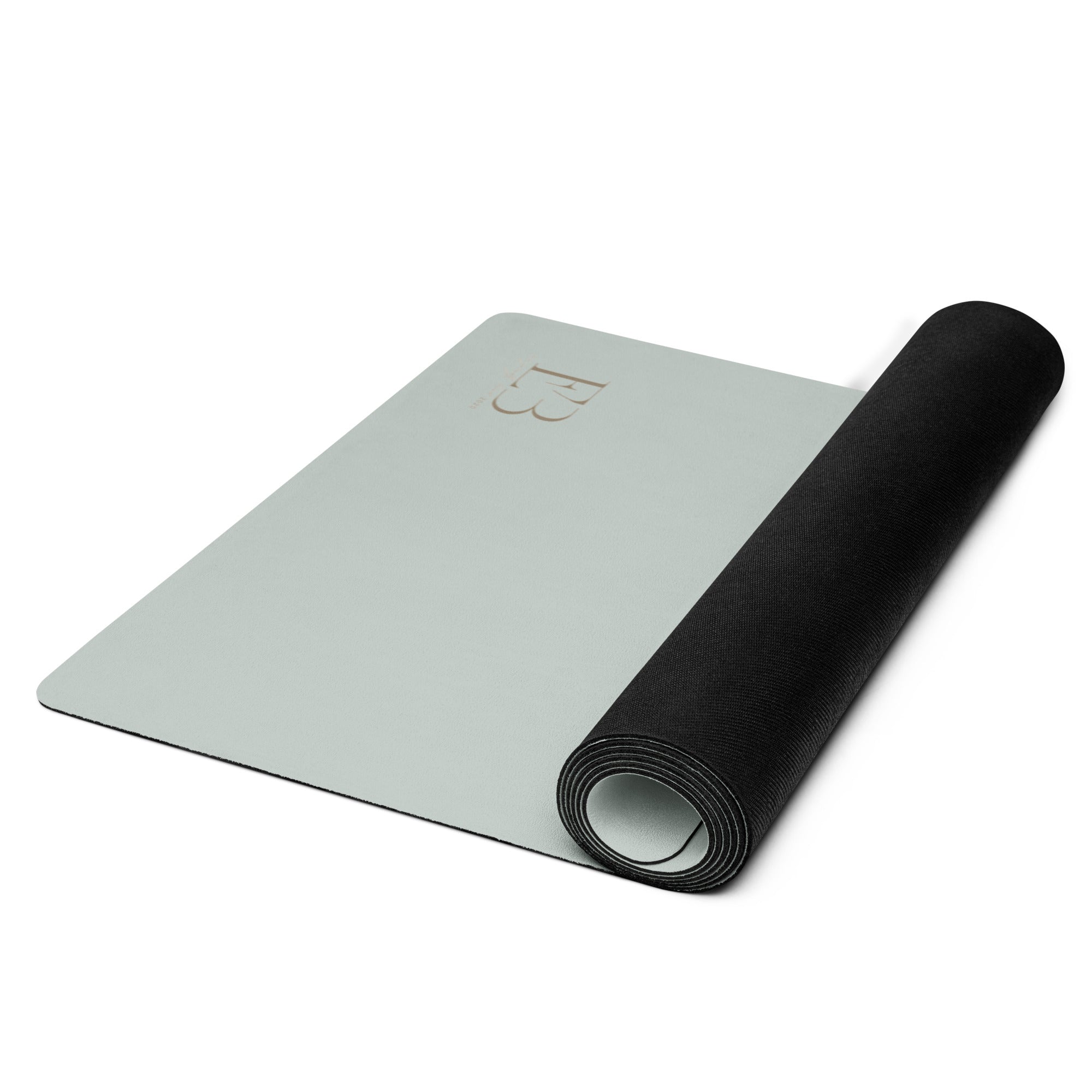 Rolled sage green natural rubber yoga mat with minimalist design
