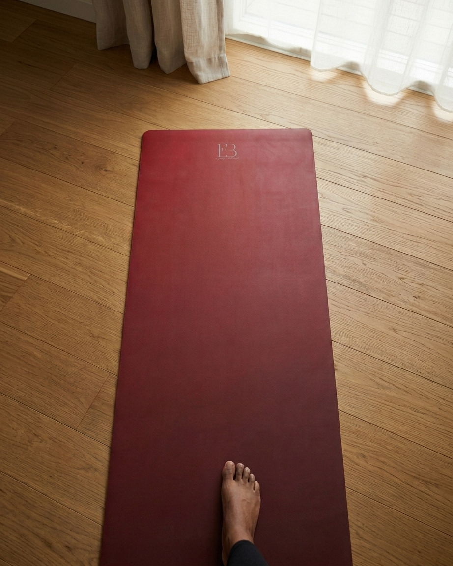 Red yoga mat with embossed logo, laid flat