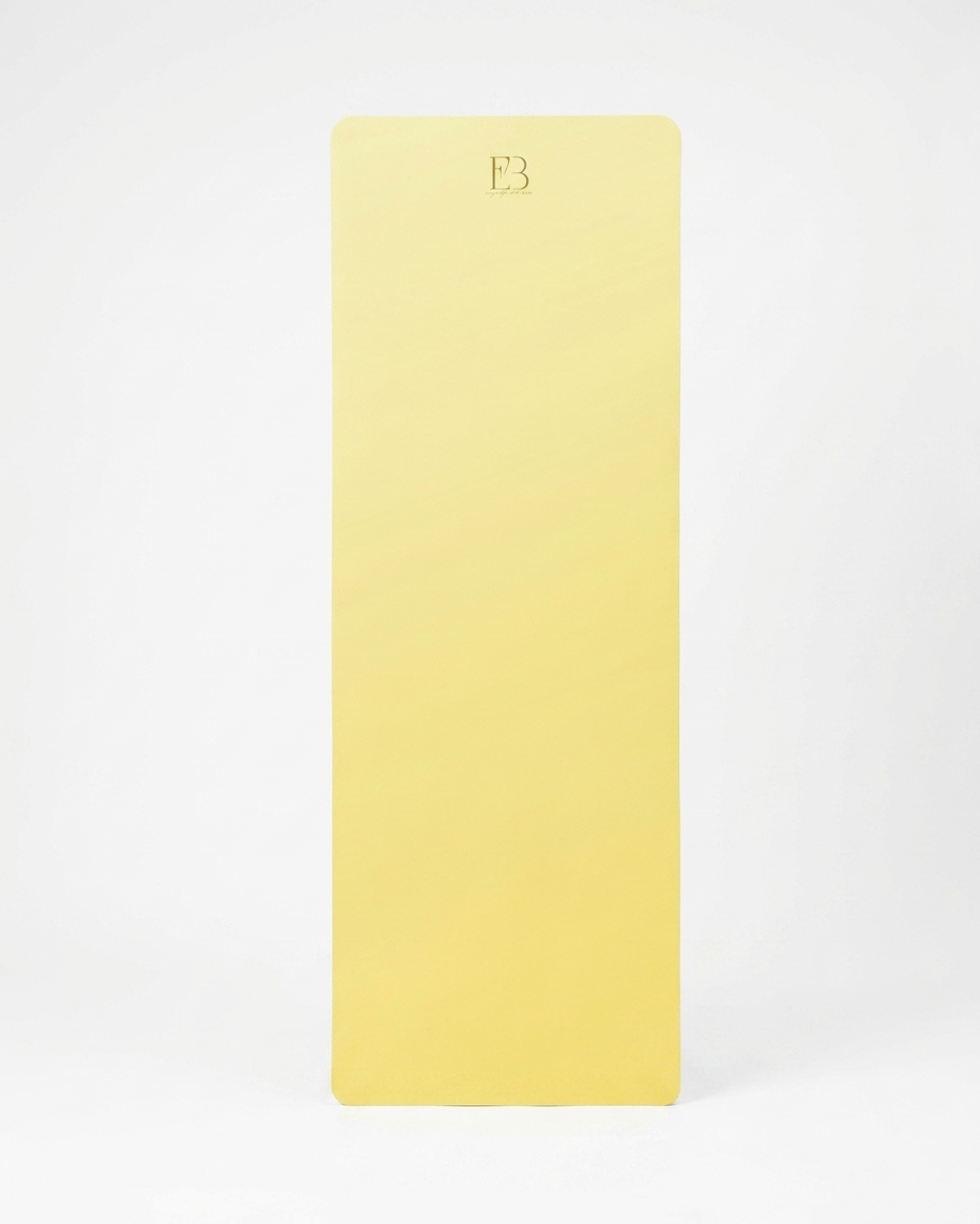 Lemon-yellow natural rubber yoga mat with centered embossed logo