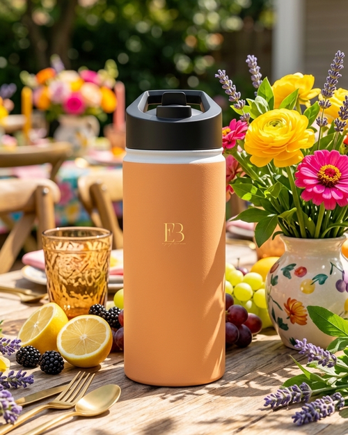 Amber insulated stainless steel water bottle standing with black lid and B3 logo