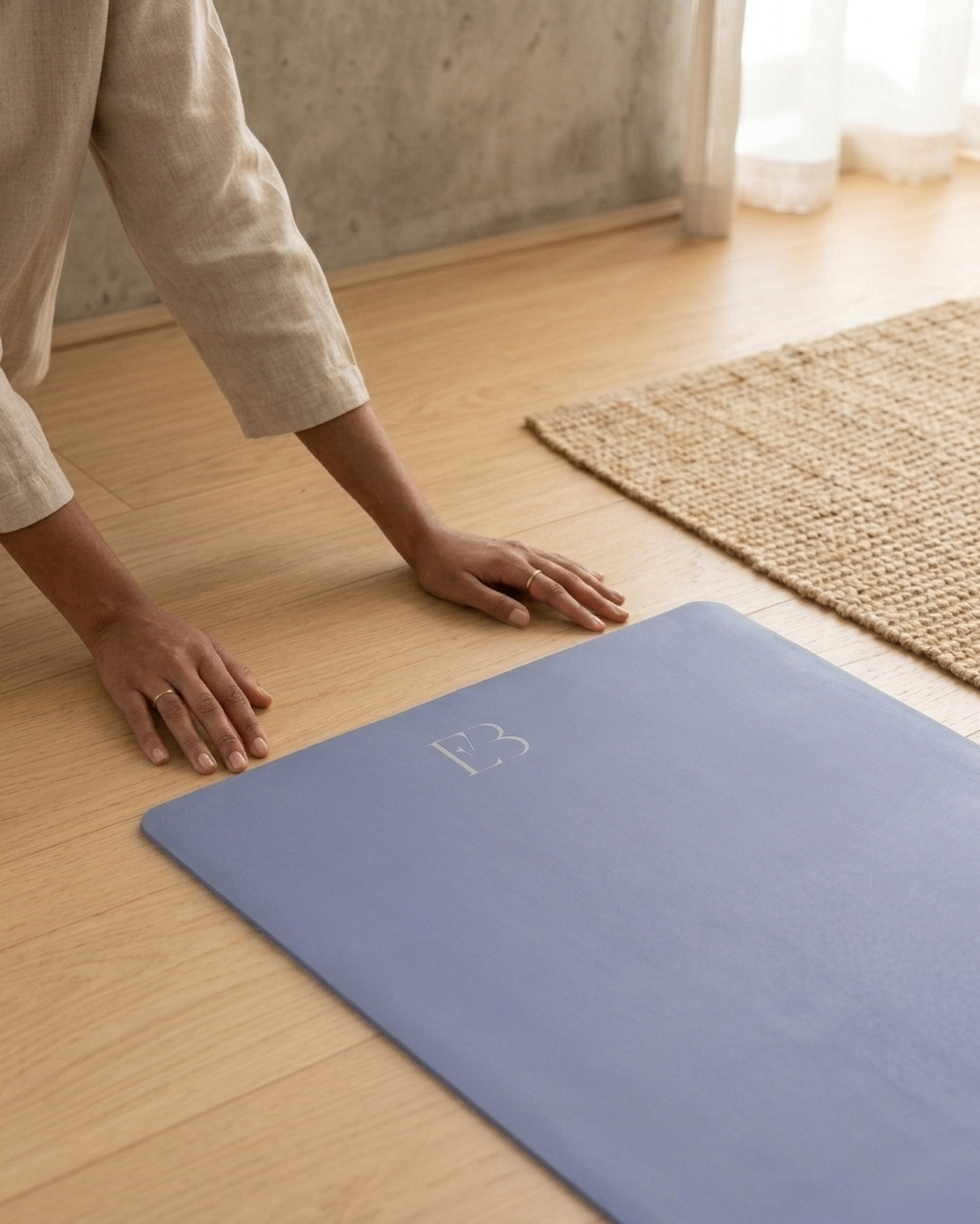 Pale iris yoga mat with embossed logo, pressed flat with hands to test grip.