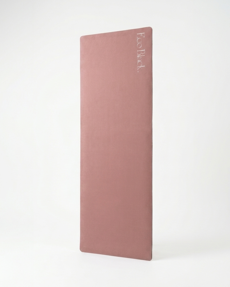 Dusty rose natural rubber yoga mat shown upright, with rounded corners and a printed logo.