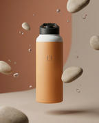 Amber insulated stainless steel water bottle with black lid, water droplets in background