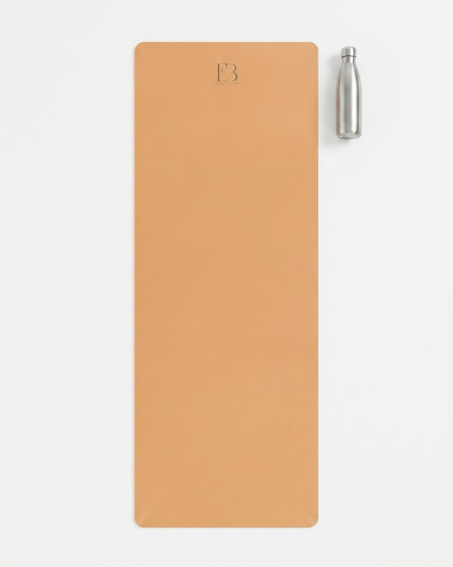 Golden yoga mat with E3 logo and a clear water bottle on a white background