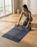 Slate blue yoga mat laid flat during kneeling stretch practice
