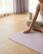 Lavender yoga mat with hands placed on top during a kneeling stretch