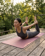 Rose-pink yoga mat on wooden deck, full mat laid flat for yoga
