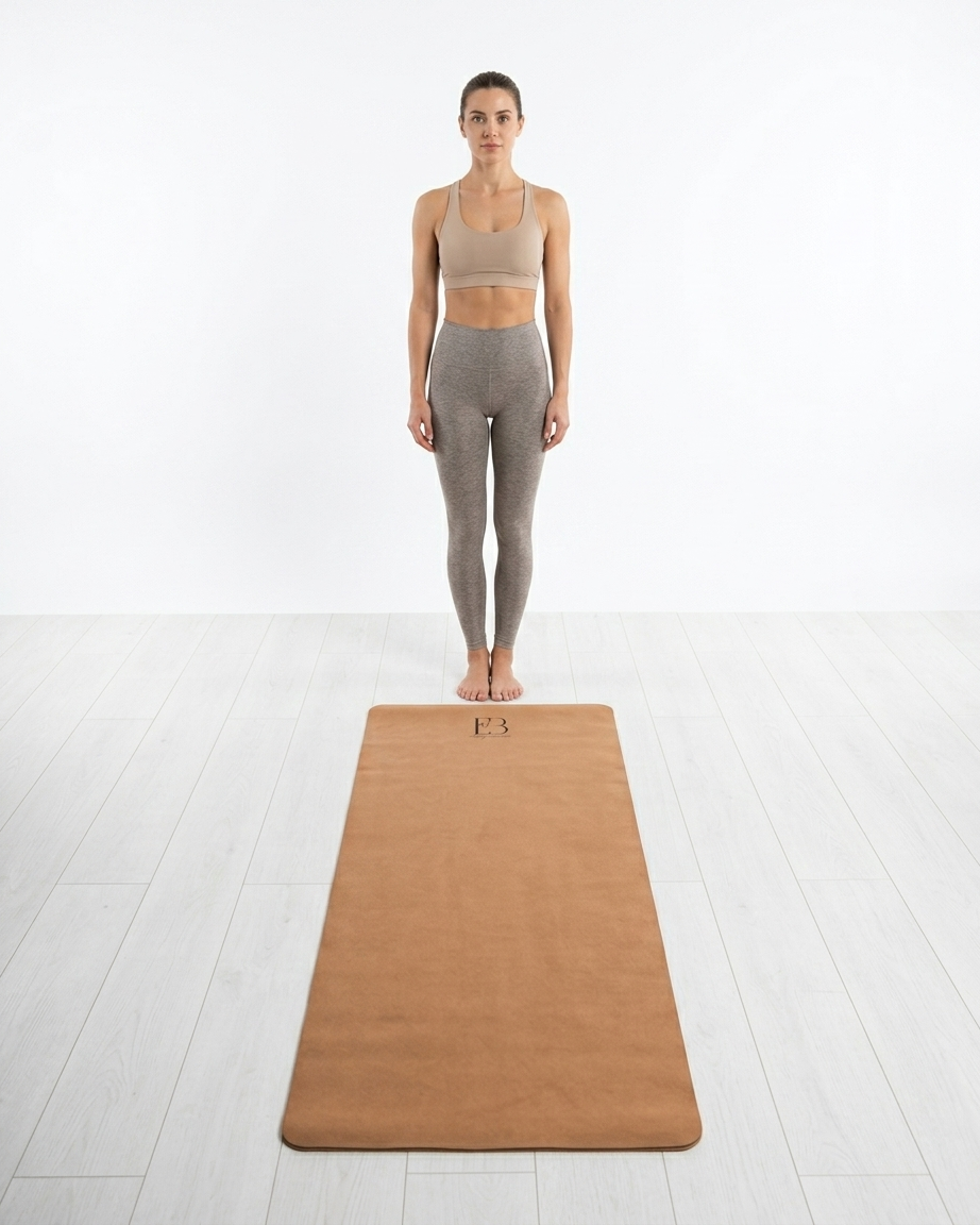Golden yoga mat on the floor under a standing pose