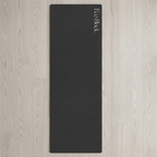 Black yoga mat standing vertically with Eco Block logo near the top.
