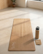Tan yoga mat with embossed logo; water bottle and product card