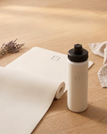 Cream yoga mat roll with cream E3 water bottle, black cap