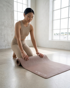 Chocolate yoga mat on the floor with white "Lopaldia" logo