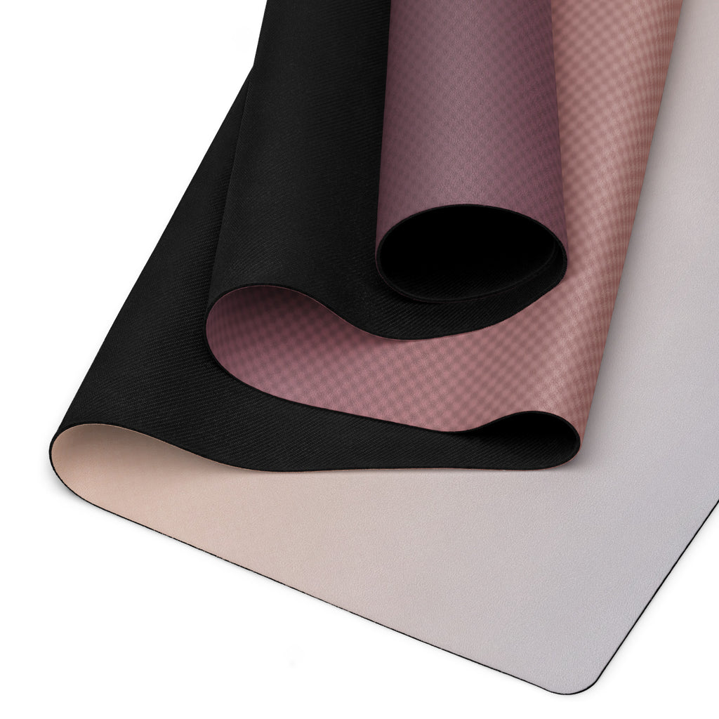 Folded yoga mat showing mauve top surface and black underside edge