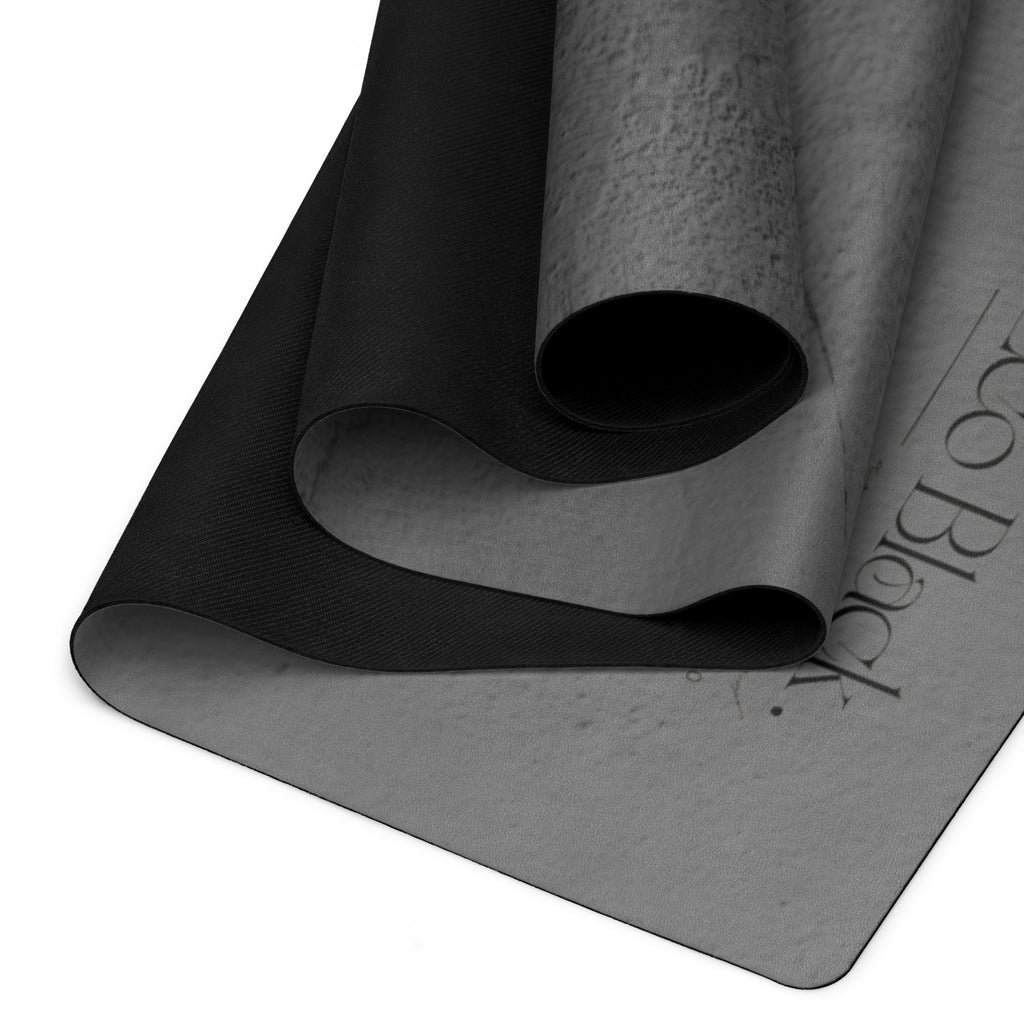 Natural rubber yoga mat with black textured surface, gray underside and rolled edge. Eco Black Dark gray natural rubber yoga mat with Suede top 