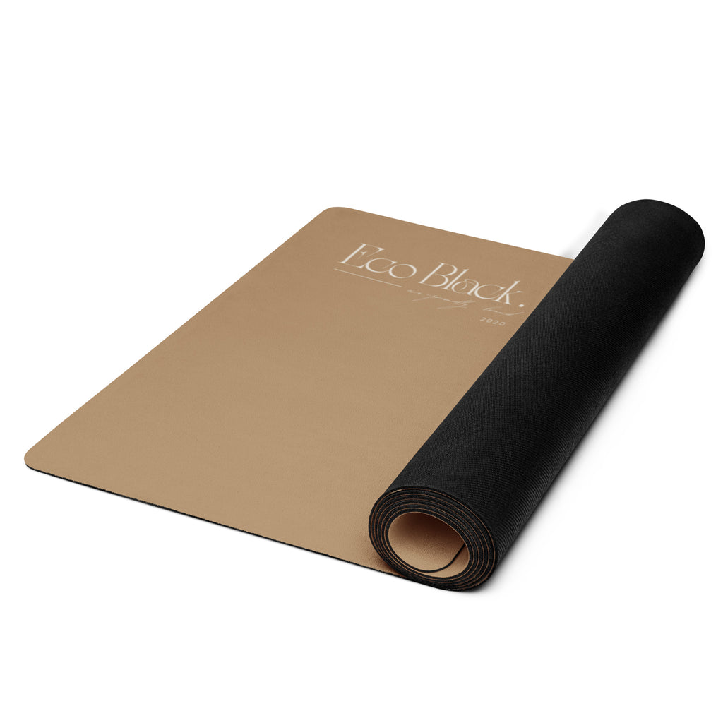 Rolled tan natural rubber yoga mat with black backing visible.