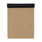 Natural rubber yoga mat flat with golden tan surface and black roll at top