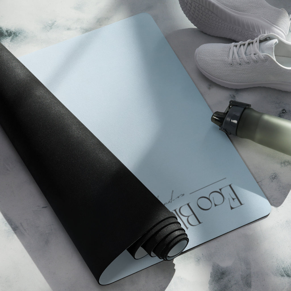 Rolled light blue yoga mat showing black textured backing and cloud print