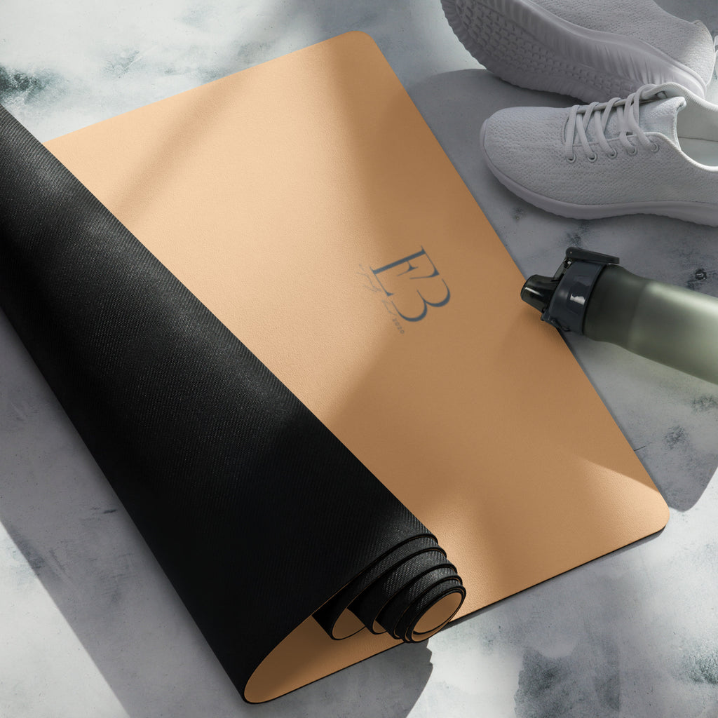 Golden yoga mat rolled with a black band, with E3 logo on the surface