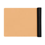 Golden yoga mat with a black rolled end, shown laid out flat