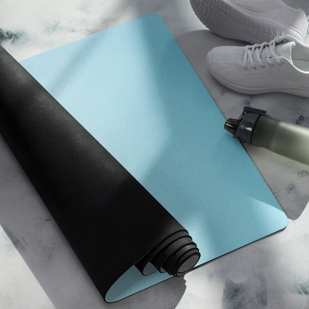 Blue yoga mat with black rolled mat beside it