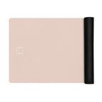 Blush pink yoga mat with black roll end and centered logo