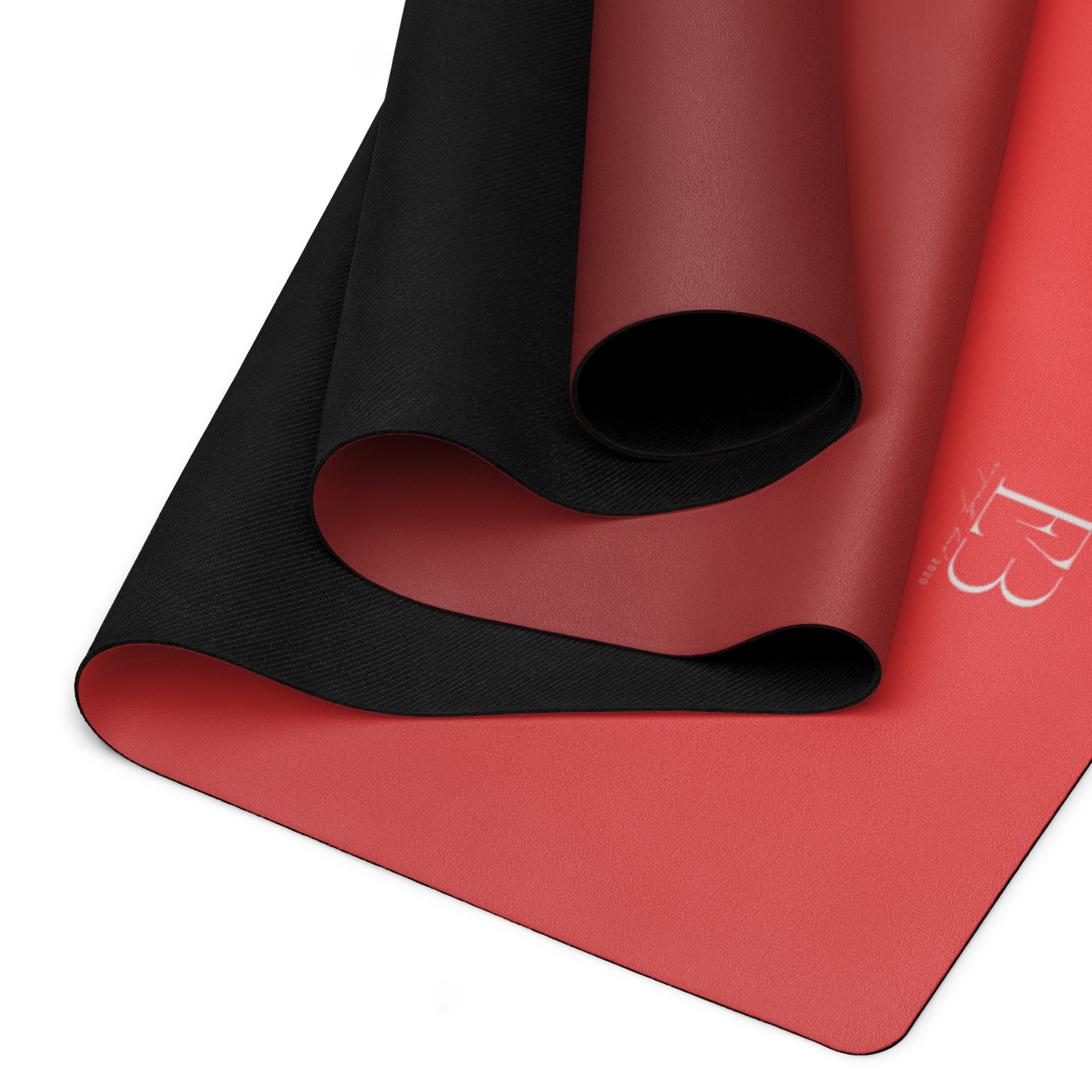 Red yoga mat showing black textured underside and ribbed grip