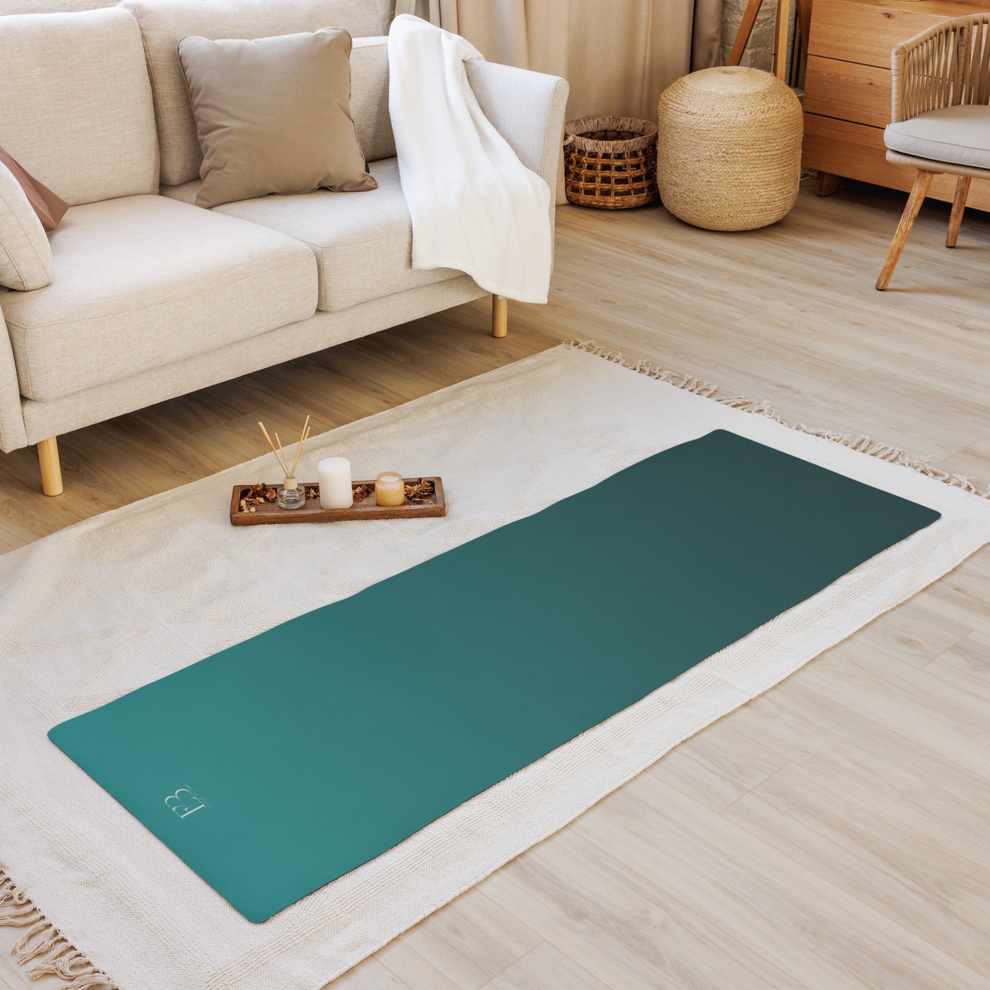 Deep teal yoga mat on a white rug in a living room setting.
