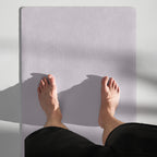 Lavender yoga mat in use for seated stretch with feet on the mat