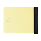 Natural rubber yoga mat with lemon-yellow surface and black rolled side