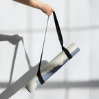 Yoga mat carried with a black strap; blue mountain haze print visible.