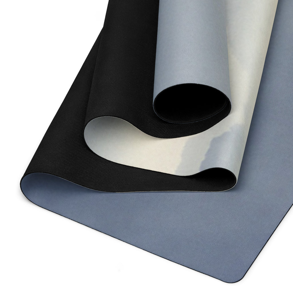 Yoga mat laid flat, showing blue-gray top and dark textured grip underside