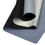 Yoga mat laid flat, showing blue-gray top and dark textured grip underside